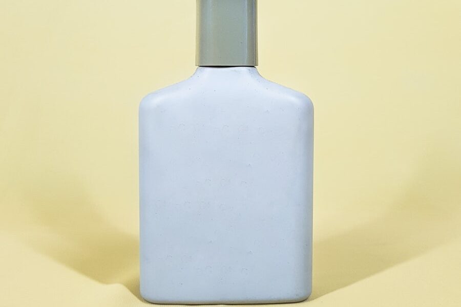 white and black bottle on yellow table